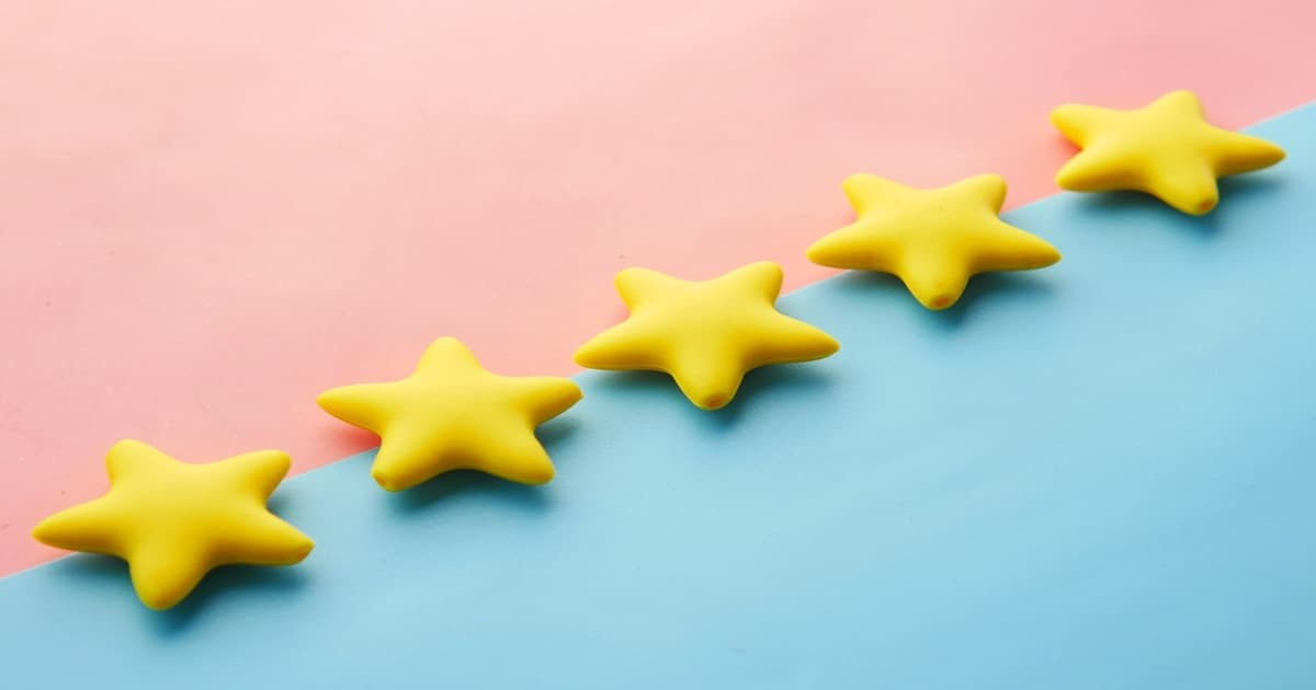 Cinco estrelas amarelas alinhadas sobre fundo colorido, simbolizando a avaliação máxima de hóspedes em plataformas de hospedagem