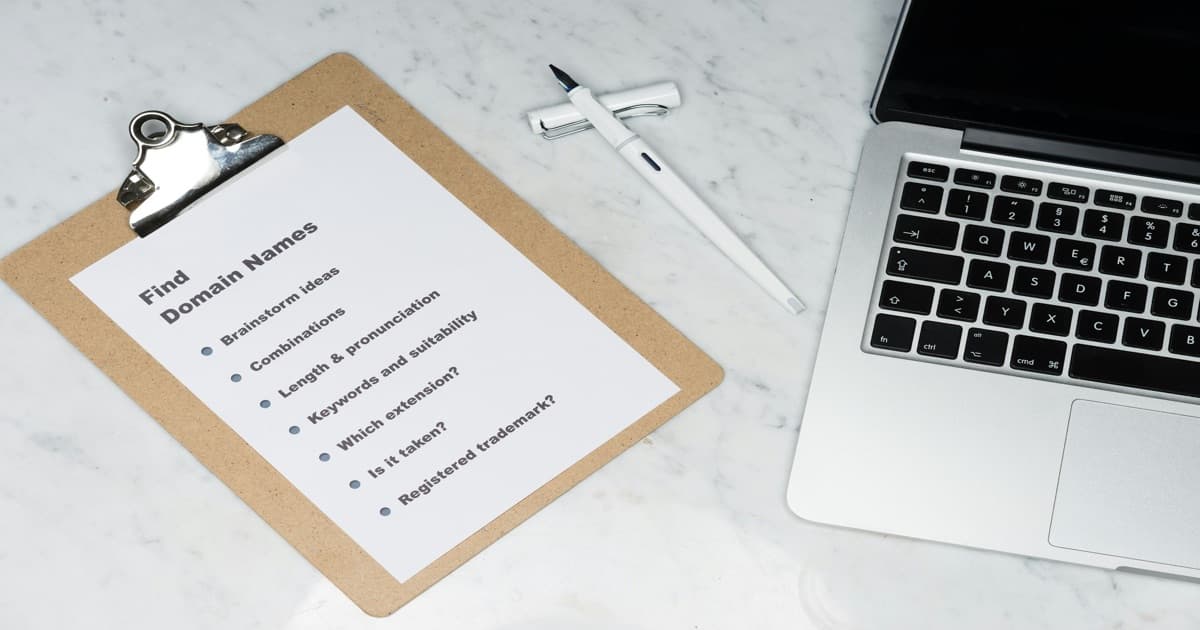 Mesa com laptop e papéis representando a comparação e configuração de sistemas de gestão para aluguel de temporada